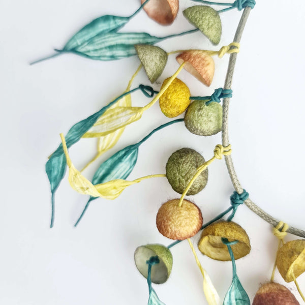 silk cocoon necklace in green hues with paper cords and yellow details by Dimitra Haratsi - Jewels My Way - The Greek Art Company